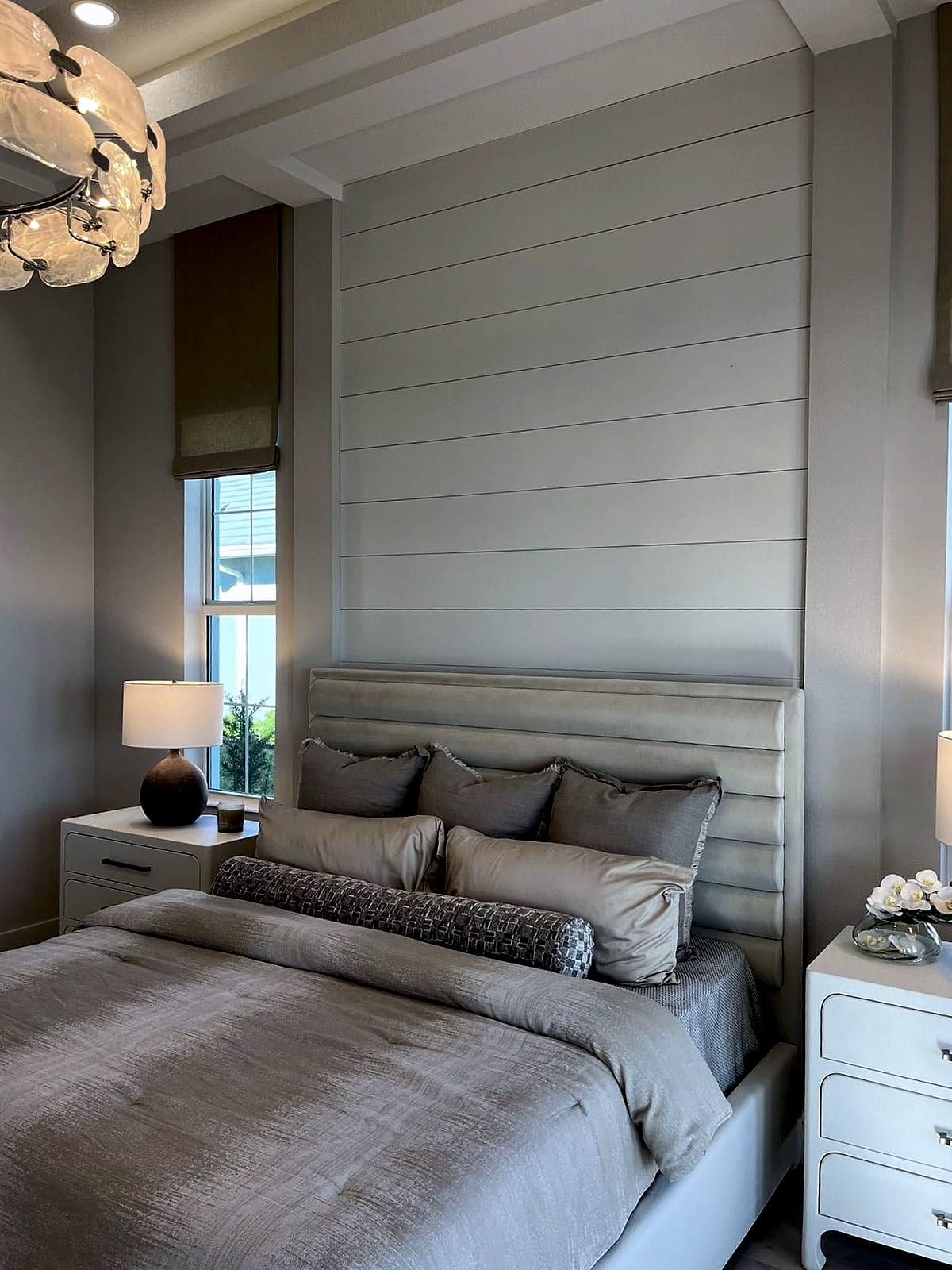 Bedroom with a full-height shiplap headboard wall